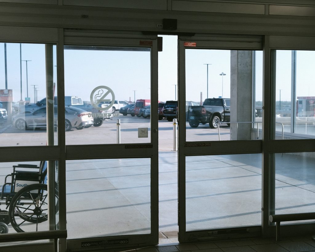 Automatic sliding doors at a hospital entrance designed for infection control and safe patient access.